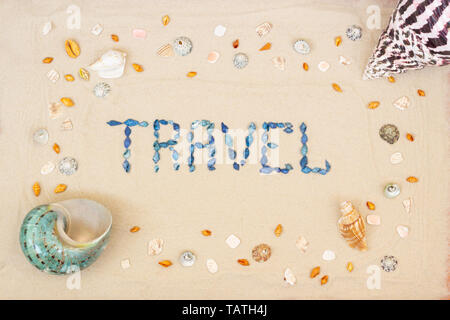 Sand on the beach in summer, the inscription travel from the shells on the sand. Close-up. Flat lay. Top view Stock Photo