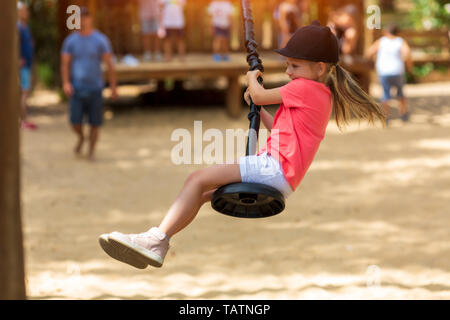 smiling girl riding a bungee in a park on the playground Stock Photo ...