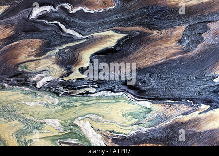 Marble stains that look like frozen lava flows, a chocolate tree, malachite emerald and black and blue shades of coal. Brown, black, green and white m Stock Photo
