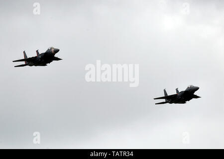 F-15E Strike Eagles from the 492nd Fighter Squadron at Royal Air Force Lakenheath fly over Imperial War Museum Duxford, England, May 26, 2019, during the Duxford Air Festival. One of the aircraft is painted in the skin of a P-47 Thunderbolt, the primary aircraft used by the wing during its service in World War II. (U.S. Air Force photo by Master Sgt. Eric Burks) Stock Photo