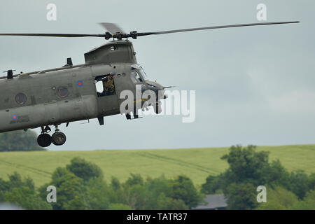 The Royal Air Force Chinook Display Team performs a demonstration during the Duxford Air Festival at Imperial War Museum Duxford, England, May 26, 2019. The Chinook is an extremely capable and highly versatile support helicopter that can be operated from land bases or seaborne vessels into a range of diverse environments, from the Arctic to the desert or jungle. (U.S. Air Force photo by Master Sgt. Eric Burks) Stock Photo