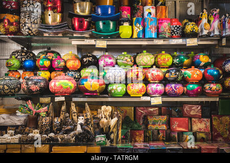 Ho Chi Minh City, Vietnam - April 8, 2019: an abundance of souvenirs (caskets, statuettes, cups, etc) on shelves in a shop in Ben Thanh Market. Stock Photo