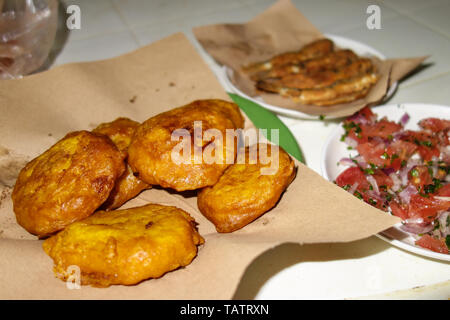 Moroccan street food: fried potato pancakes or hash browns served with a tomato salad and sardines in the medina of Fez, Morocco Stock Photo