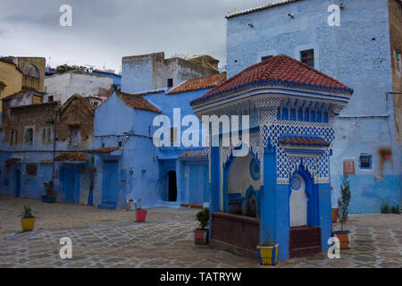 Traditional moroccan architectural details on a square with water well in the Blue City, Chefchaouen, Morocco Stock Photo