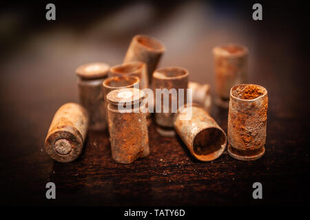 A pile bullet shells on a wooden background Stock Photo