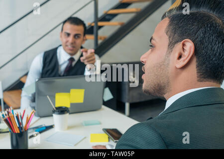 The young man is a business conversation with colleagues in the office. Business training. Stock Photo