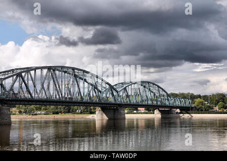 Poland - Torun famous truss bridge over Vistula river. Transportation infrastructure. Storm clouds. Stock Photo