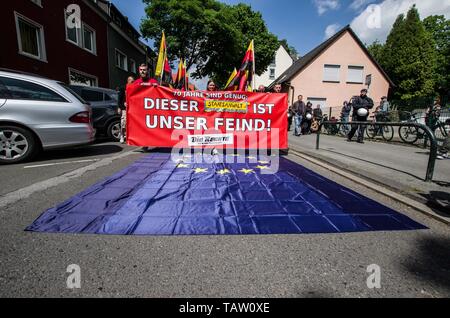 Dortmund, Nordrhein Westfalen, Germany. 25th May, 2019. Neonazis in Dortmund, Germany trample over the European Union flag during their march. Prior to the European Elections, the neonazi party Die Rechte (The Right) organized a rally in the German city of Dortmund to promote their candidate, the incarcerated Holocaust denier Ursula Haverbeck. The demonstration and march were organized by prominent local political figure and neonazi activist Michael Brueck (Michael BrÃ¼ck) who enlisted the help of not only German neonazis, but also assistance from Russian, Bulgarian, Hungarian, and Dutch grou Stock Photo