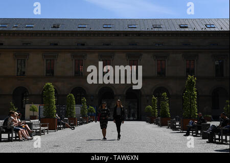 Munich, Germany. 24th May, 2019. People walk on a square ouside the Munich Residenz in Munich, Germany, May 24, 2019. Located in the northern foothills of the Alps in southern Germany, Munich is the capital of the state of Bavaria. It is one of Germany's major economic, cultural, scientific, technological and transportation centers and one of Europe's most prosperous cities. Credit: Lu Yang/Xinhua/Alamy Live News Stock Photo