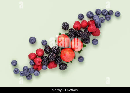 Fresh Summer Berries on plain green background Stock Photo