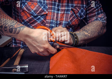 Leather Professional making quality products in his workshop. Stock Photo