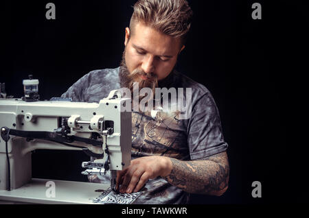 Man working with leather creating new leatherwork . Stock Photo