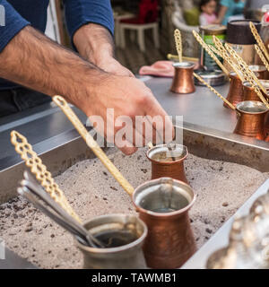 Cooking turkish coffee on hot sand in cezve Stock Photo