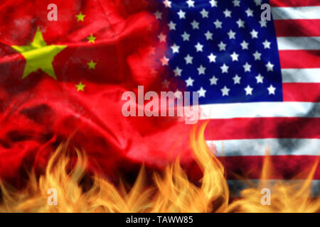 waving USA and China flag with fire on foreground. serious trade tension or trade war between US and China, financial concept Stock Photo