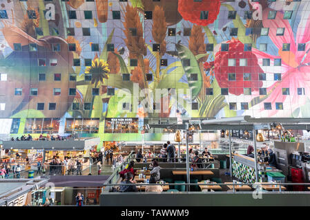Rotterdam, Netherlands - May 2, 2019 : People eating in an elevated restaurant inside the markthal open food market Stock Photo