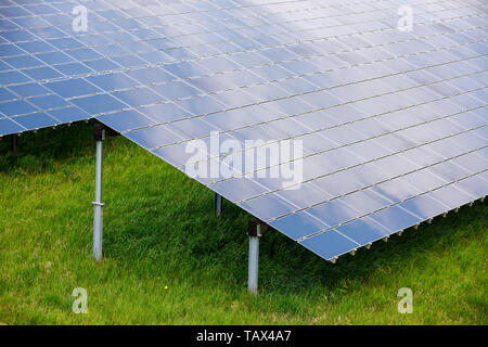 Array of Solar panels at Photovoltaic power station or Solar farm absorb sunlight to generate electricity Stock Photo