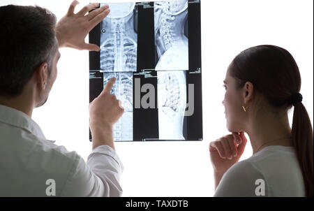 Two doctors discussing patients x-ray and MRI scans, Spine x-rays Stock Photo