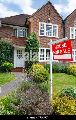 House for sale sign outside a typical UK semi-detached house in London Stock Photo