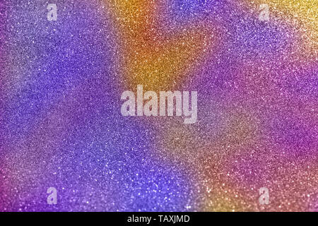 Abstract blurred of gold and purple glittering shine bulbs lights background. Blur of Christmas wallpaper decorations concept. Multicolored glitter ba Stock Photo