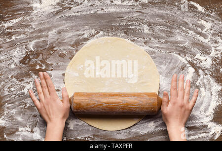 Chef Rolling Dough For Pizza On Table Stock Photo
