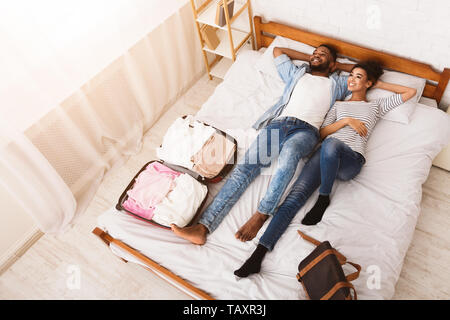 Arrival At Hotel. Couple Lying On Bed Stock Photo