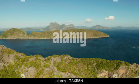 Bay and the tropical islands. Seascape with tropical rocky islands, ocean blue wate, aerial view. islands and mountains covered with tropical forest. El nido, Philippines, Palawan. Tropical Mountain Range