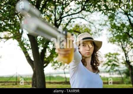 Face of aiming sport female shooter during concentration before shot, outdoor training Stock Photo