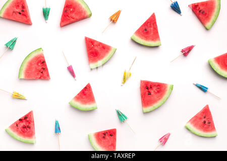 Fresh watermelon slices and colorful paper cocktail umbrellas Stock Photo