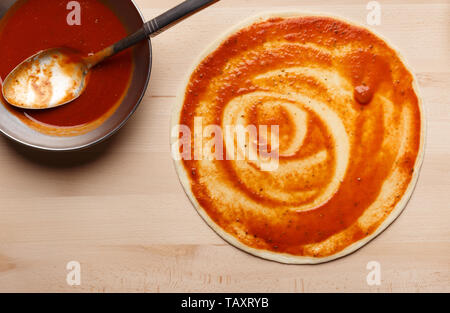 Pizza Preparation. Raw Pizza Base With Ketchup Stock Photo