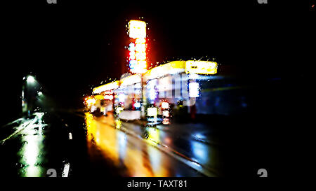 Illuminated gas station in rainy night ver.1 Stock Photo