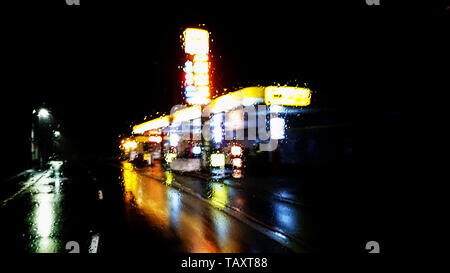 Illuminated gas station in rainy night ver.2 Stock Photo