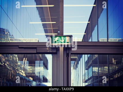 emergency exit sign inside a modern office building Stock Photo