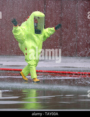 fireman wears a special phosphorescent protective suit to extinguish a fire Stock Photo