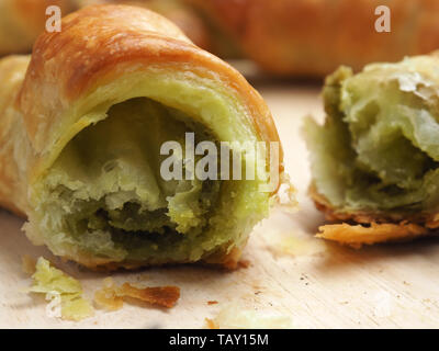 Tasty croissants with matcha on a cutting board, healthy breakfast concept Stock Photo