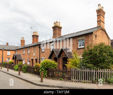 A row of six, Grade II listed, brick-built almshouses in The Square, Dunchurch, near Rugby, Warwickshire, UK. Stock Photo