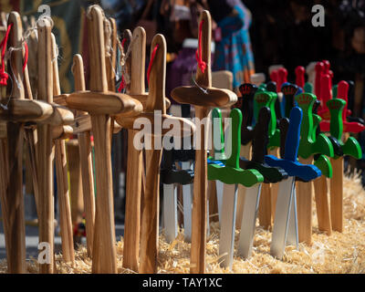 Street stall in a medieval market with wooden swords for children to buy and play. Stock Photo