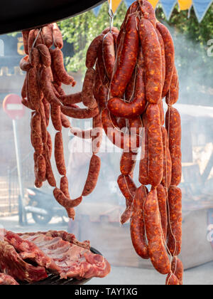 Stand of hanging chorizos for their preparation and later consumption. Stock Photo