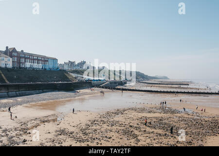 Cromer, UK - April 20, 2019: High angle view of the Cromer beach, people in the distance. Cromer is a seaside town in Norfolk and a popular family hol Stock Photo