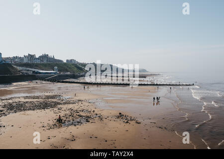 Cromer, UK - April 20, 2019: High angle view of the Cromer beach, people in the distance. Cromer is a seaside town in Norfolk and a popular family hol Stock Photo