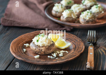 Baked mushrooms stuffed with risotto Stock Photo