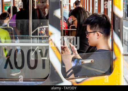 Passengers On Board A Traditional Hong Kong Electric Tram, Hong Kong, China Stock Photo