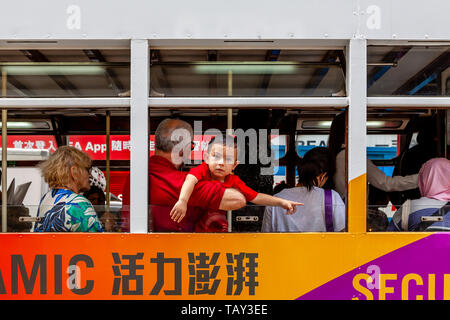 A Child Looks Out Of The Window Of A Traditional Hong Kong Electric Tram, Hong Kong, China Stock Photo