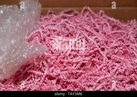Close up of pink packing paper and bubble wrap in a box Stock Photo