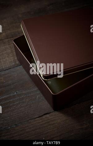 Brown metal box on a wooden table. Stock Photo