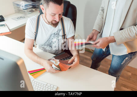 Creatives working in team checking colors for advertising project Stock Photo