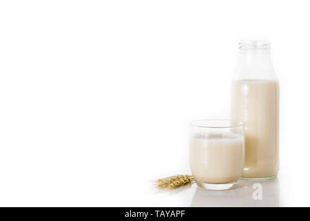Oats milk in bottle and glass isolated on white background Stock Photo
