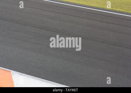 Image of a stretch of paved road with brightly colored margins Stock Photo