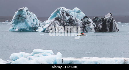 Huge iceberg and resque boat in Iceland Jokulsarlon Stock Photo