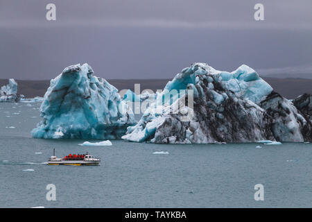 Huge iceberg and resque boat in Iceland Jokulsarlon Stock Photo