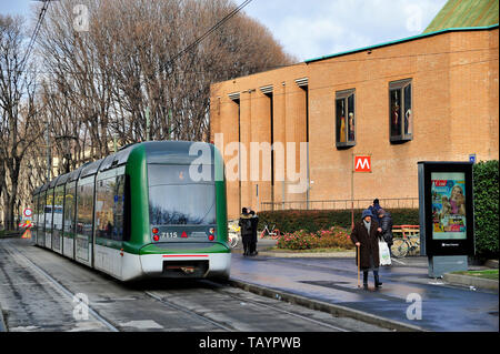 A tram runs along a Milan street. The public transport company in Milan (ATM) is very efficient, on top of Italian standards. Stock Photo
